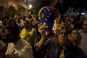 epa05057854 People celebrate in a street in Caracas, Venezuela, early 07 December 2015, after the Venezuelan National Election Council's President, Tibisay Lucena (unseen), announced that Venezuelan opposition coalition Mesa de Unidad Democratica (MUD) won the legislative election. The Venezuelan opposition won national elections by a landslide, the head of the election council said early 07 December, with at least 99 of the 167 seats confirmed for the alliance of the MUD. It was the first defeat of the socialist movement since its founder Hugo Chavez came to power in a 1998 election. EPA/MIGUEL GUTIERREZ