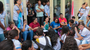 #pracegover: prefeita de Caruaru, Raquel Lyra, está rodeada de estudantes da rede de ensino estadual